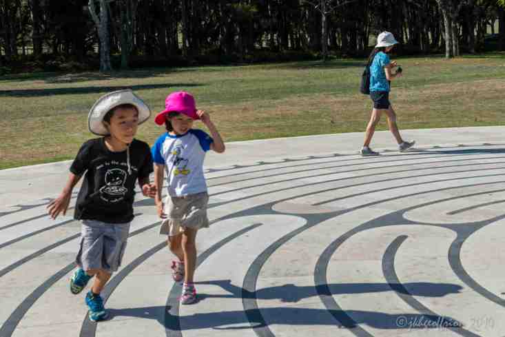Family wlaking and running the Centennial Parklands Labyrinth