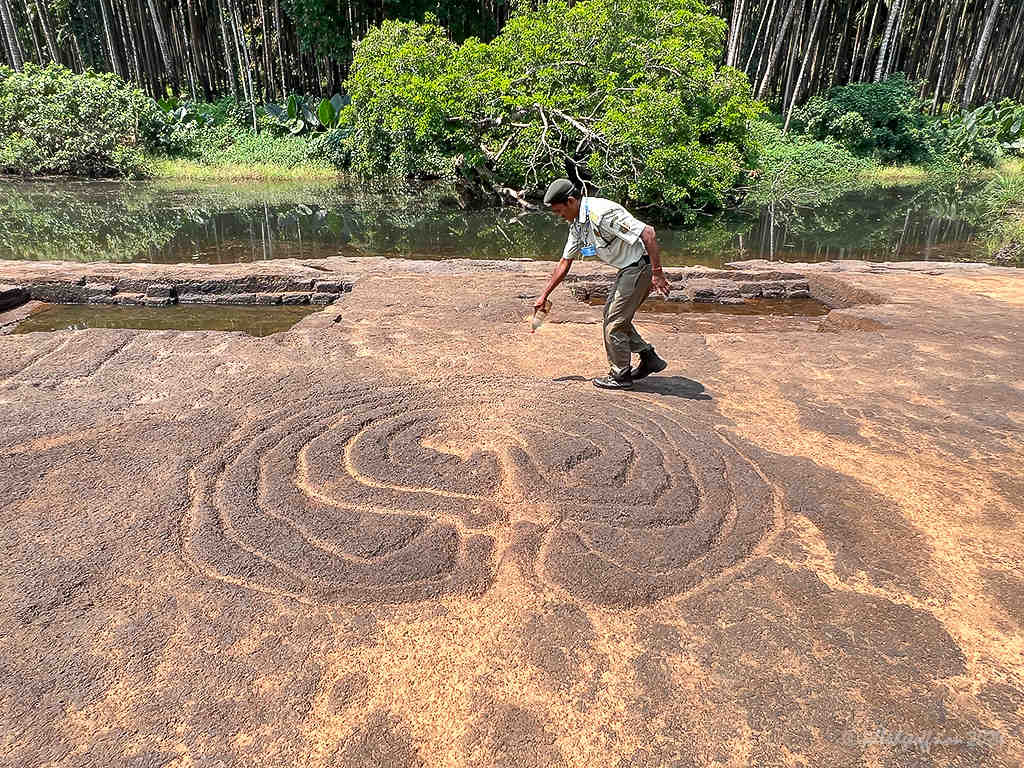Guide pouring water over the labyrinth lines